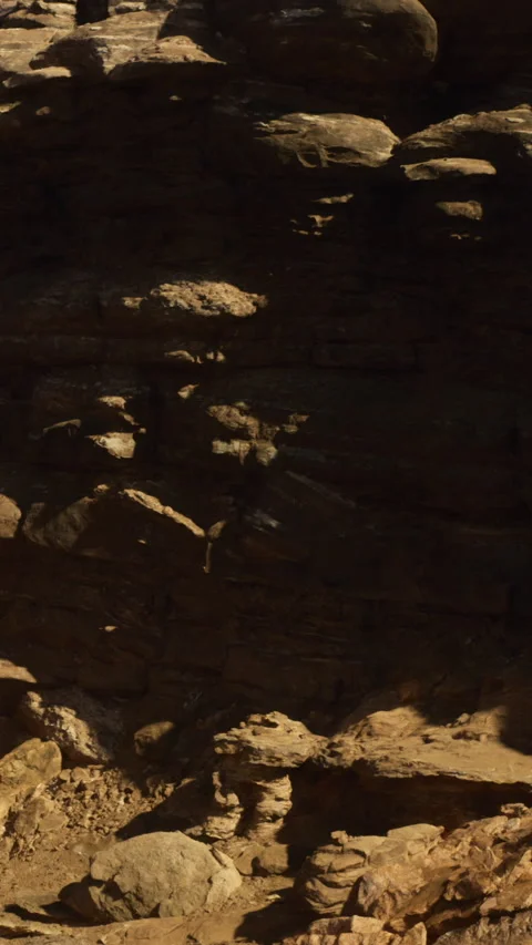 Mysterious rock formations casting shadows in the desert sunlight Stock Footage 331829198