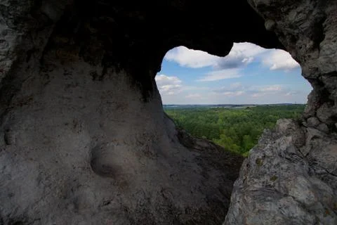 A mysterious rock with an opening through it Stock Photos