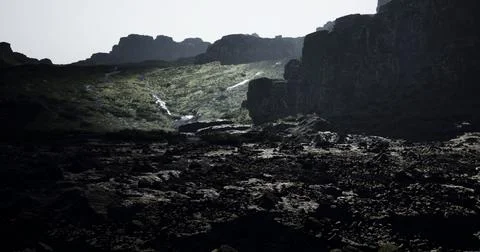 Mysterious rocky landscape with shadowed cliffs and illuminated terrain Stock Illustration