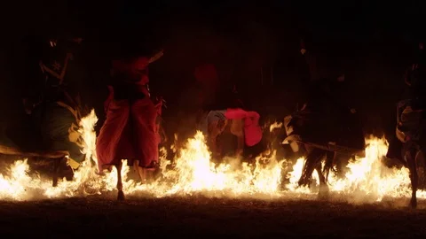 Mysterious Silhouettes of People in Front of Fire - Knights fighting Stock Footage 70140763