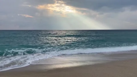 Mysterious sun rays reach out the sea with waves on the coast of Alanya 스톡 동영상 283757098
