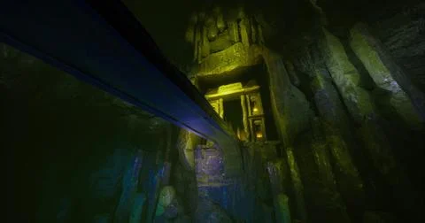 Mysterious underground chamber with glowing structures and shadows Stock Illustration