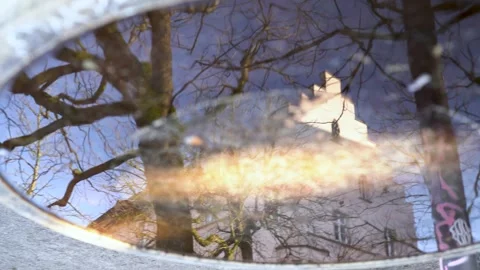 Mysterious upside down reflection of wishing well fountain with trees and church Stock Footage 263645568
