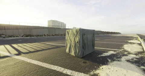 Mysterious wrapped package sits alone on empty street near the beach Vídeo Stock 306156908