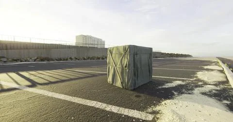 Mysterious wrapped package sits alone on empty street near the beach Stock Illustration