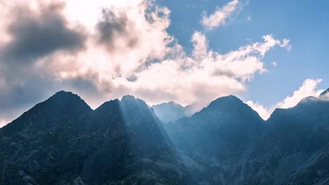 Mystic light sunrays, clouds motion in misty alps mountain landscape Time lapse Stock Footage 154470954