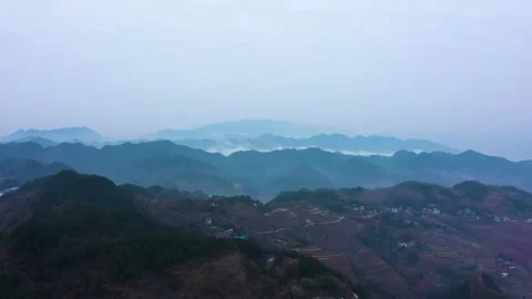 Mystical 4K Aerial View of Cloud Covered Karst Mountains in Fairyland Setting Stock Footage 320111534