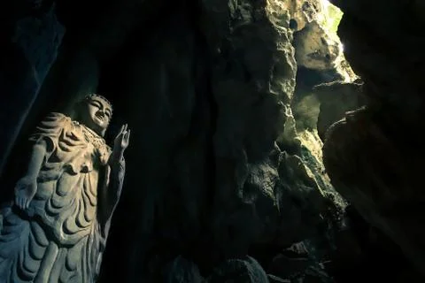 Mystical Buddha statue inside a cave (wider angle) Stock Photos