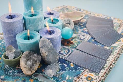 Mystical Card Reading Setup. Blue candles, crystals, and tarot cards on a Stock Photos