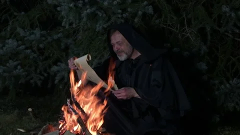 A mystical character studies an ancient parchment. Stock Footage 315010015