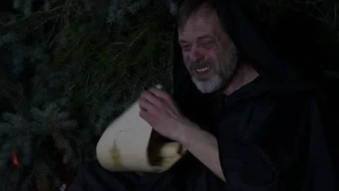 A mystical character studies an ancient parchment Stock Footage 315010019