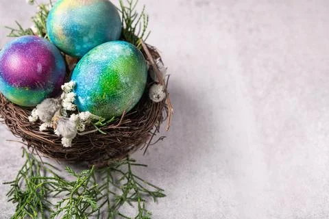 Mystical coloring Easter eggs with twigs and spring flowers Stock Photos