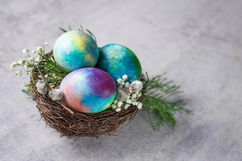 Mystical coloring Easter eggs with twigs and spring flowers Stock Photos