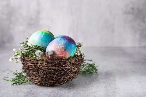 Mystical coloring Easter eggs with twigs and spring flowers Stock Photos