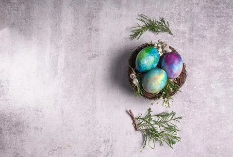 Mystical coloring Easter eggs with twigs and spring flowers Stock Photos
