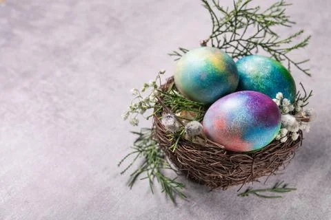 Mystical coloring Easter eggs with twigs and spring flowers Stock Photos