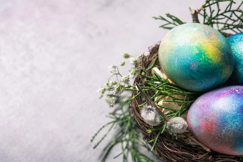 Mystical coloring Easter eggs with twigs and spring flowers Stock Photos