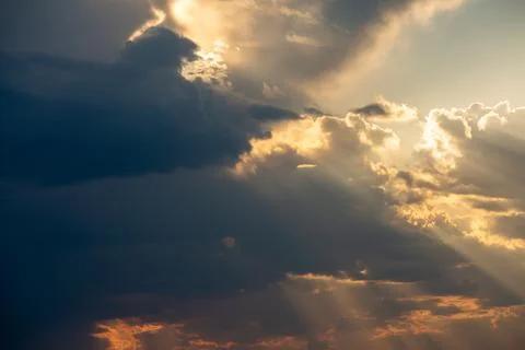 Mystical dramatic cloudy sky with sun behind the clouds and rays of light .Sky Stock Photos