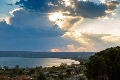 Mystical dramatic cloudy sky with the sun behind the clouds and rays of light Stock Photos
