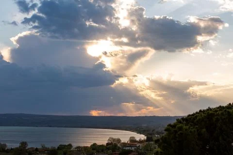 Mystical dramatic cloudy sky with the sun behind the clouds and rays of light on Stock Photos