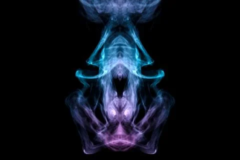 A mystical image of a ghost head or an alien from green and purple smoke. Pri Stock Photos