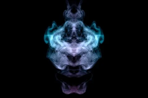 A mystical image of a ghost head or an alien from green and purple smoke. Pri Stock Photos