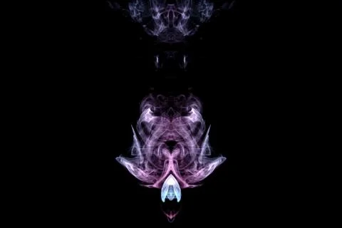 A mystical image of a ghost head or an alien from green and purple smoke. Pri Stock Photos