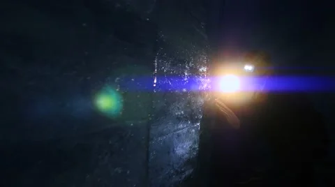 Mystical scene of man walking through dark ice cave holding flashlight Video stock 64799613