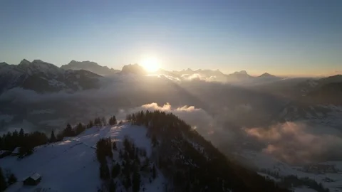 Mystical sunbeams shine through clouds and high mountain summit, aerial rotate Stock Footage 169547456