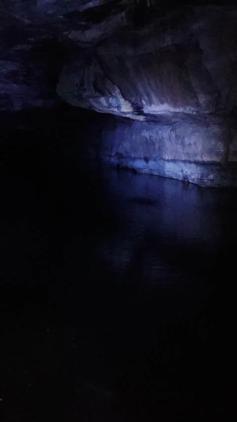 Mystical underground cave with a cascade falling from into a still water Video stock 310142904