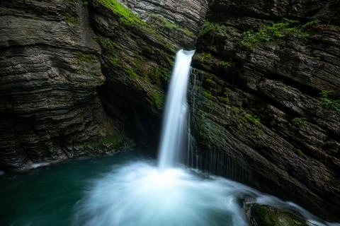 A mystical waterfall surrounded by moss Stock Photos