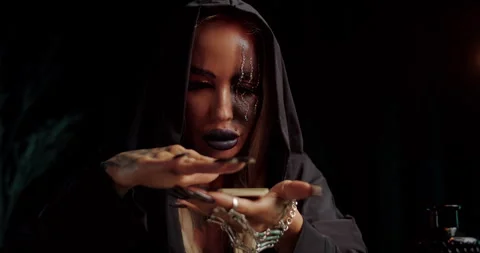 Mystical witch performing hand ritual with intense focus Stock Footage 319606152