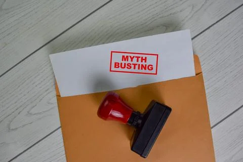 Myth Busting text on document above brown envelope. Stock Photos