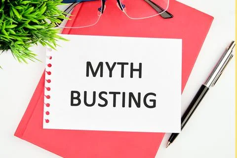Myth busting word concept in a white notebook on a red business book Stock Photos