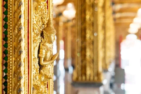 Mythical protector figures across temple wall gilded high relief gold surfa.. Foto stock