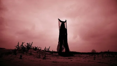 Mythological concept / Red sky and woman with horns in a wasteland Stock-Footage 80986815
