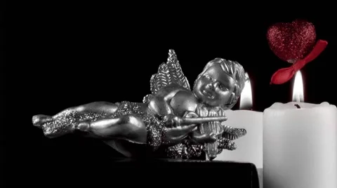 Mythological Figurine with Candles and Red Heart Stock Footage 59741443