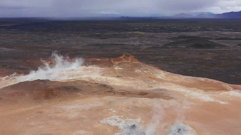 Myvatn, Bubbling pools of mud and steaming fumaroles emitting sulfuric gas Stock Footage 116203707