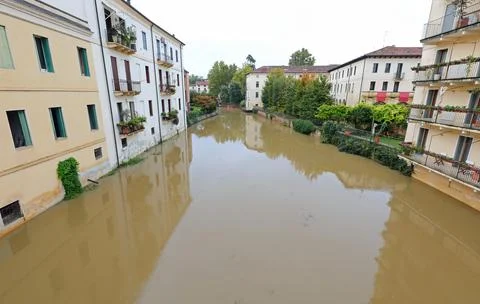 N river is lapping at the foundations of flood-risk homes during a deluge c.. Stock Photos