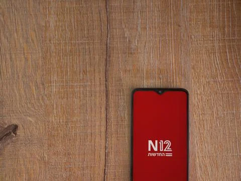 N12 app launch screen with logo on the display of a black mobile smartphone o Stock Photos