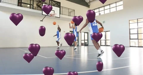N12 bouncing ball passing shooting hoops drill while team rotating purple hearts Stock Footage 328583061
