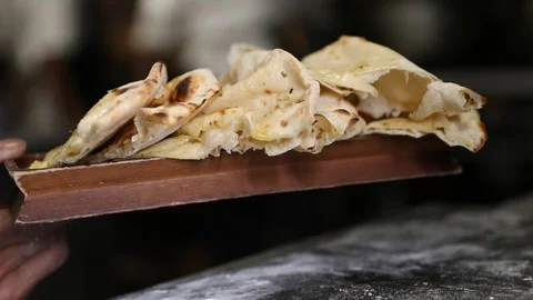 Naan Bread Being Lifted on Board Stock Footage 102010603