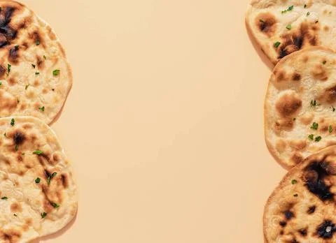 Naan flatbread on cream background, copy space Pattern of fesh naan bread ... Stock Photos