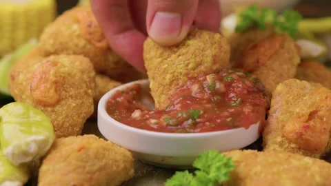 Nacho Cheese Bites with Salsa, Corn and Pickled Peppers on Wooden Board Stock Footage 345677181