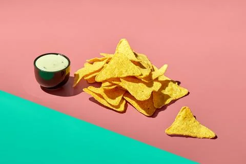 Nachos corn chips with ranch sauce on a colored background. Mexican cuisine Stock Photos