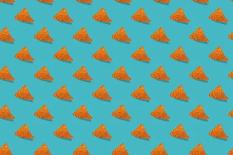 Nachos corn chips seamless pattern on blue background. Stock Photos