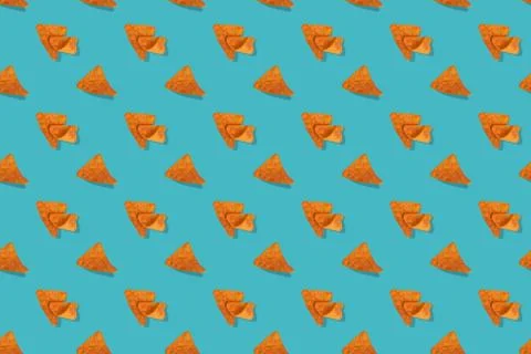 Nachos corn chips seamless pattern on blue background. Stock Photos