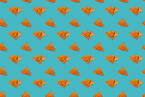 Nachos corn chips seamless pattern on blue background. Stock Photos