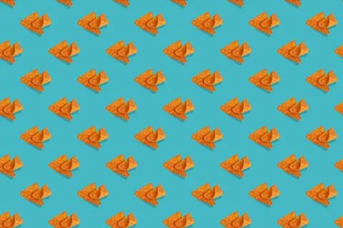Nachos corn chips seamless pattern on blue background. Stock Photos