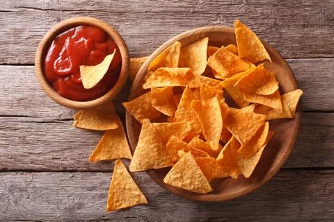 Nachos corn chips with spicy sauce on the table. horizontal view from above Stock Photos